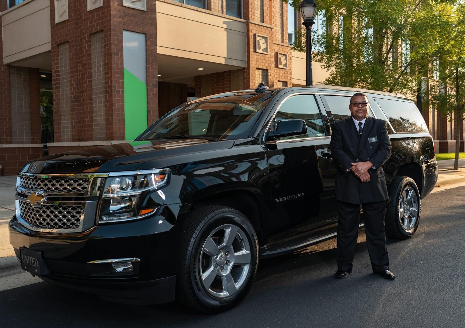 Space AAM LLC professional chauffeur next to a premium vehicle
